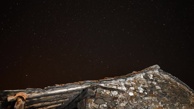 Old stone house and star trail time lapse
