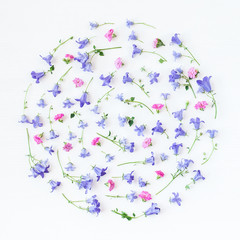 Pattern made of bellflower, pansy flowers and pink flowers on white background. Flat lay, top view