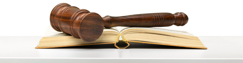 Wooden gavel and books on wooden table