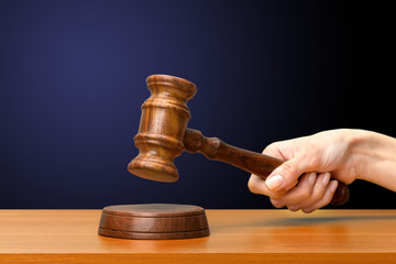 someones hand holding Wooden Law Gavel