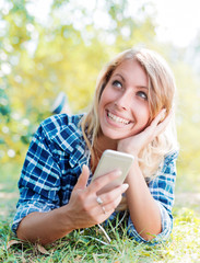 Young woman listening to music on a smart phone