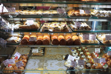 Various type of cakes in shop window in Italy