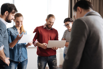 Company of five people actively discussing new project