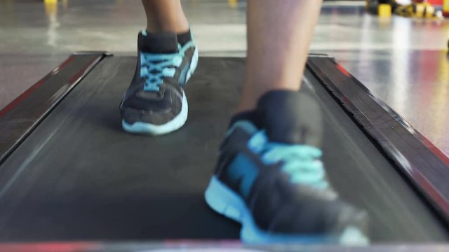 Cardio workout, Afro-American man exercising on treadmill in the gym, close-up