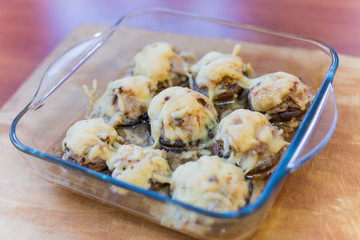 Stuffed mushrooms champignons with cheese cooked in the oven