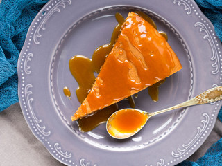 Chocolate cocoa butter cake with caramel on rustic background