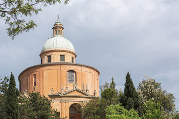 Fototapeta na wymiar Old orange church with cloudy sky as background In Italy, Bologna (Sanctuary of the Madonna of San Luca)