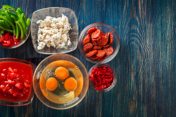 Ingredients for preparing frittata - eggs, sausage chorizo, red