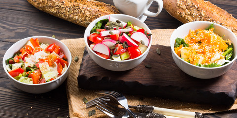 Colorful vegetable salad bowl for lunch on wooden rustic background