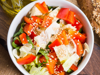 Colorful vegetable salad bowl for lunch on wooden rustic background