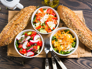 Colorful vegetable salad bowl for lunch on wooden rustic background