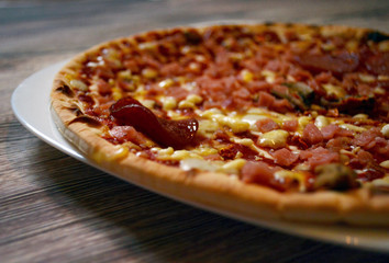 thin pizza on a wooden table
