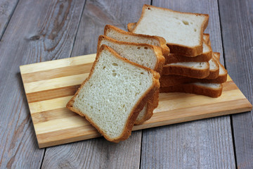 pieces of wheat bread on a cutting Board.