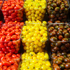 Colorful cherry tomatoes in plastic baskets