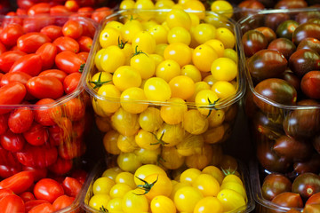 Colorful cherry tomatoes in plastic baskets
