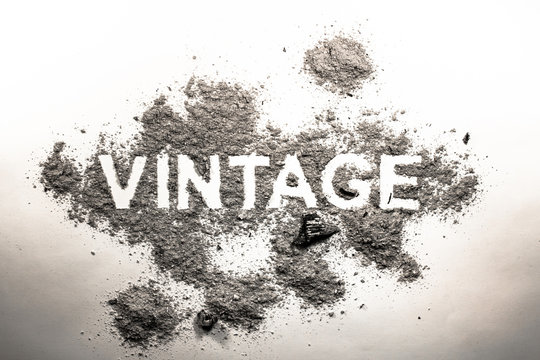 Word vintage written in dust, ash, dirt as a rustic outdated dirty industry symbol concept text