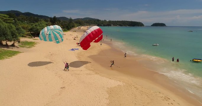 Aerial view of parasailing under beauterful bay and beach. Drone video of parasailing. Phuket, Karon beach, Thailand 2017