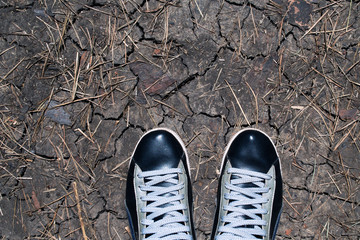 Sneakers on the cracked earth