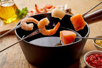 Pink prawns and fresh salmon in a seafood fondue