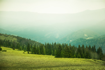 Fototapeta premium A beautiful mountain pass landscape of Tatra mountains in Slovakia. Colorful warm spring haze look.