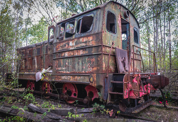 Fototapeta na wymiar Old rusty locomotive near Prypiat ghost town of Chernobyl Exclusion Zone, Ukraine