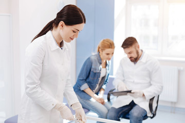 Fototapeta premium Nice professional doctor preparing a syringe