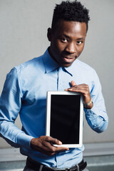 African american man in blue shirt using tablet PC