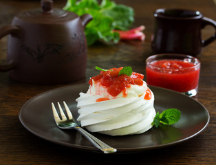 Dessert of meringue with rhubarb and mint sauce.