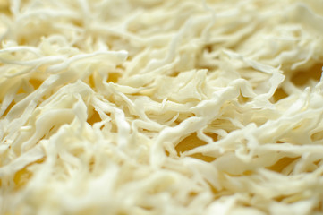 Sliced white cabbage on a yellow cutting board