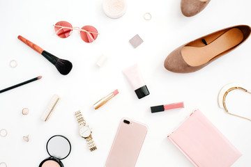 Beauty blog fashion concept. Female pink styled accessories: mobile phone, watches, sunglasses, cosmetics, shoes on white background. Flat lay, top view trendy feminine background.
