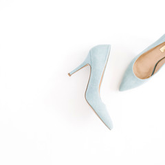 Beauty blog concept. Pale blue female shoes on white background. Flat lay, top view trendy fashion feminine background.