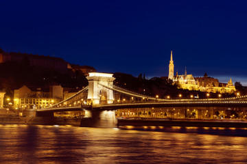 Fototapeta na wymiar Beautiful night Budapest, the Chain bridge across the Danube river in lights with dark blue sky, Travel outdoor sightseeing european background.