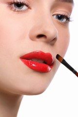 Naklejka premium Make-up artist apply lipstick with brush, beauty