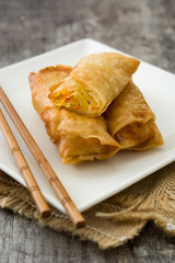 Vegetable spring rolls on wooden table background
