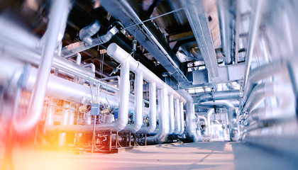 Industrial Factory. Various mechanisms and metal pipes. Toned image. Motion blur effect.