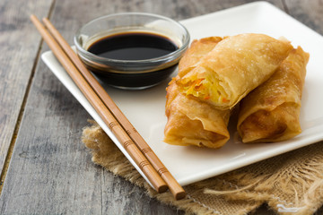 Vegetable spring rolls on wooden table background
