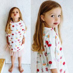 Beautiful little girl model  posing in dress against colorful wall