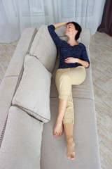 beautiful young woman lying on the couch