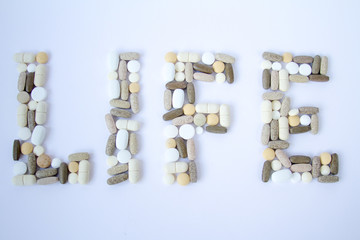 Colorful medical pills loose on a white background.