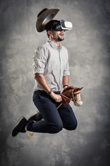 young caucasian adult man enjoy experiencing immersive Virtual Reality cowboy game simulation.VR...