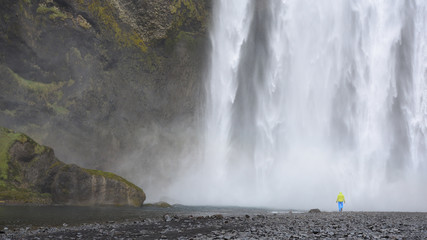 Man by a waterfall in Iceland - obrazy, fototapety, plakaty