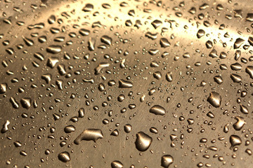 Raindrops pattern on a shiny metallic surface