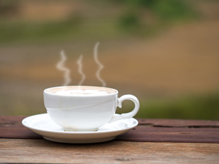 Coffee cup on straw in the rise fields,soft focus