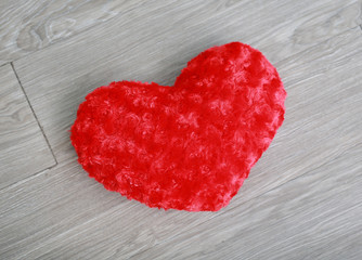 Obraz na płótnie Canvas Red heart pillow on wood background.