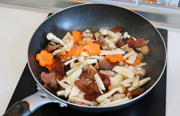 Homemade cooking. Fried shiitake mushroom with pork, tofu and carrot.