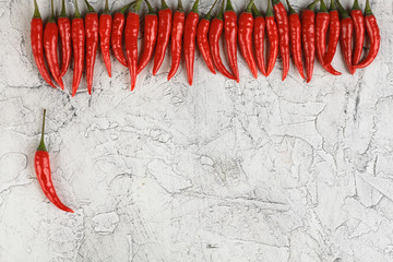 Red Hot chili pepper on a white cement background. White concrete background.