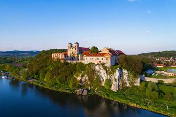 Fototapeta na wymiar Benedictine abbey on the rocky hill in Tyniec near Cracow, Poland and Vistula River. Aerial view at sunset