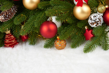 Naklejka na ściany i meble christmas decoration on fir tree branch closeup, gifts, xmas ball, cone and other object on white blank space fur, holiday concept, place for text