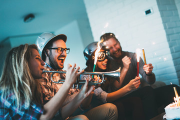 Group of friends enjoying and celebrating birthday and partying