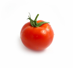 Photo depicts a bright red color natural beautiful delicious single fresh tomato with water drops, isolated on a white background. Delicious single fresh tomato with dew drops. Close up, top view.